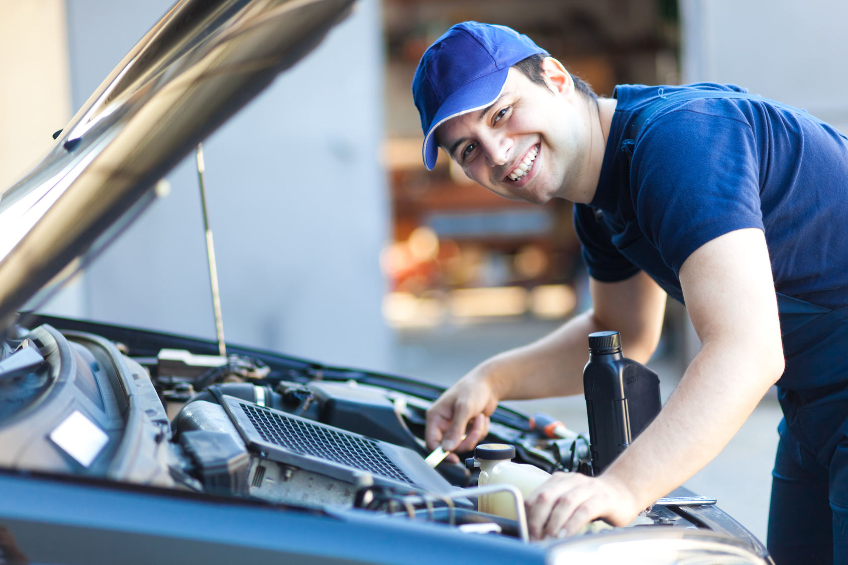 A mechanic services a car engine