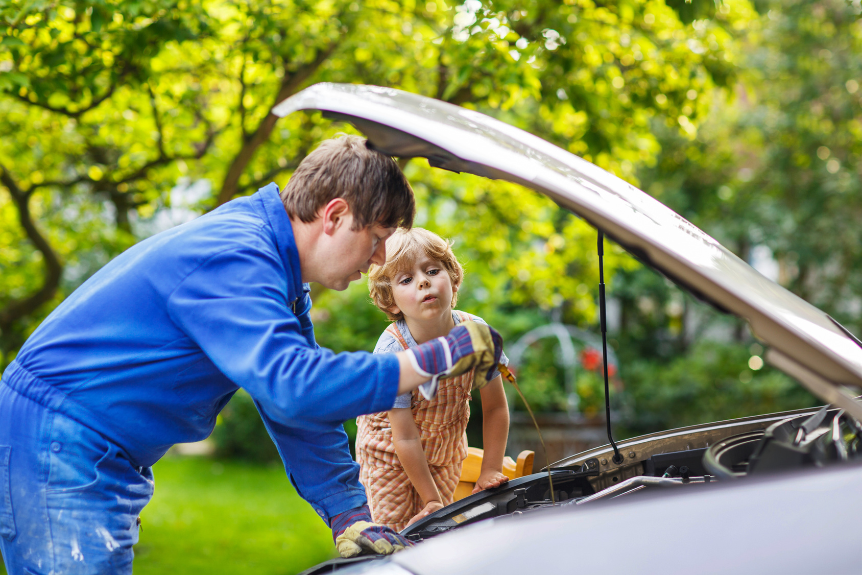 Father teaching son car care