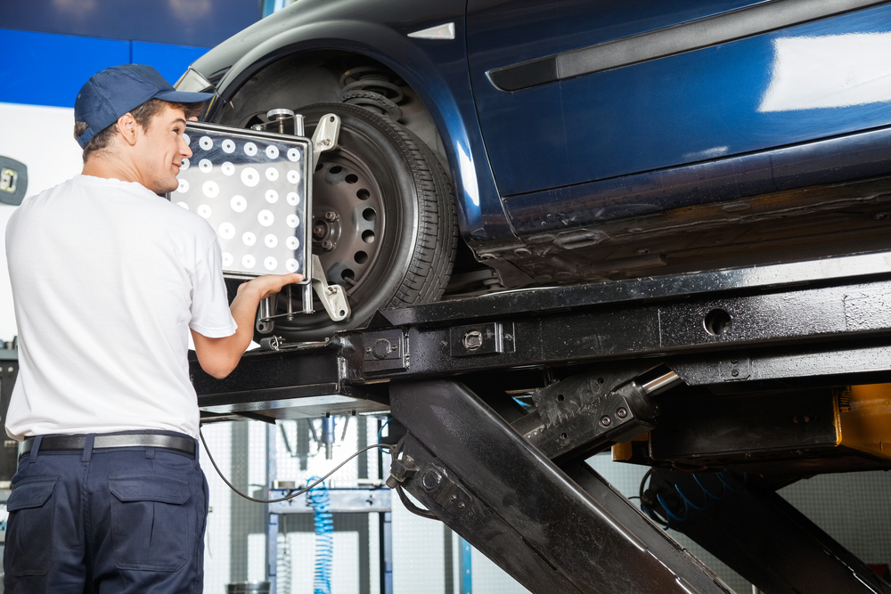 Mechanic aligns car tire