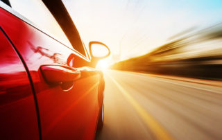 A car driving on a motorway at high speeds, overtaking other cars