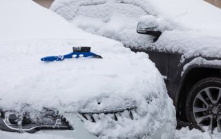 snowy cars in parking lot during winter
