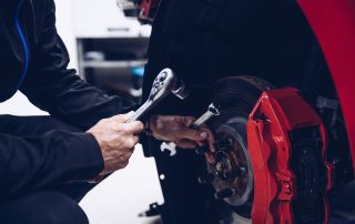 mechanic changing car brakes